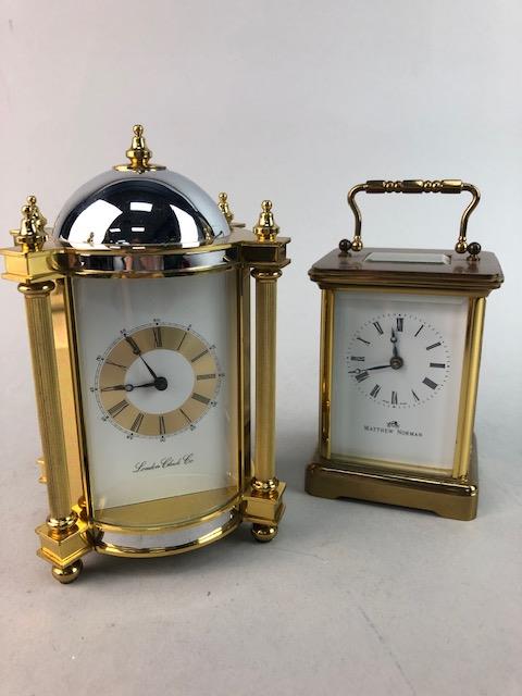 A MATTHEW NORMAN CARRIAGE CLOCK, ANOTHER CARRIAGE CLOCK AND TWO MANTEL CLOCKS