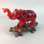 A CHINESE RED BAKELITE MODEL OF AN ELEPHANT