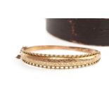 A NINE CARAT GOLD BANGLE WITH CHARM AND RING