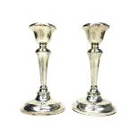 A PAIR OF GEORGE V SILVER CANDLESTICKS