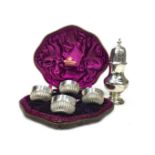 A SILVER SUGAR CASTER AND FOUR SALT DISHES