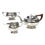 A SILVER THREE PIECE TEA SERVICE