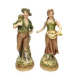 A PAIR OF ROYAL DUX FIGURES OF YOUNG FARMHANDS