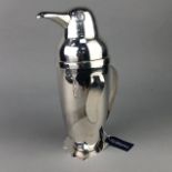 A WHITE METAL COCKTAIL SHAKER IN THE FORM OF A PENGUIN