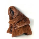 A FUR COAT ALONG WITH A STOLE AND HAT