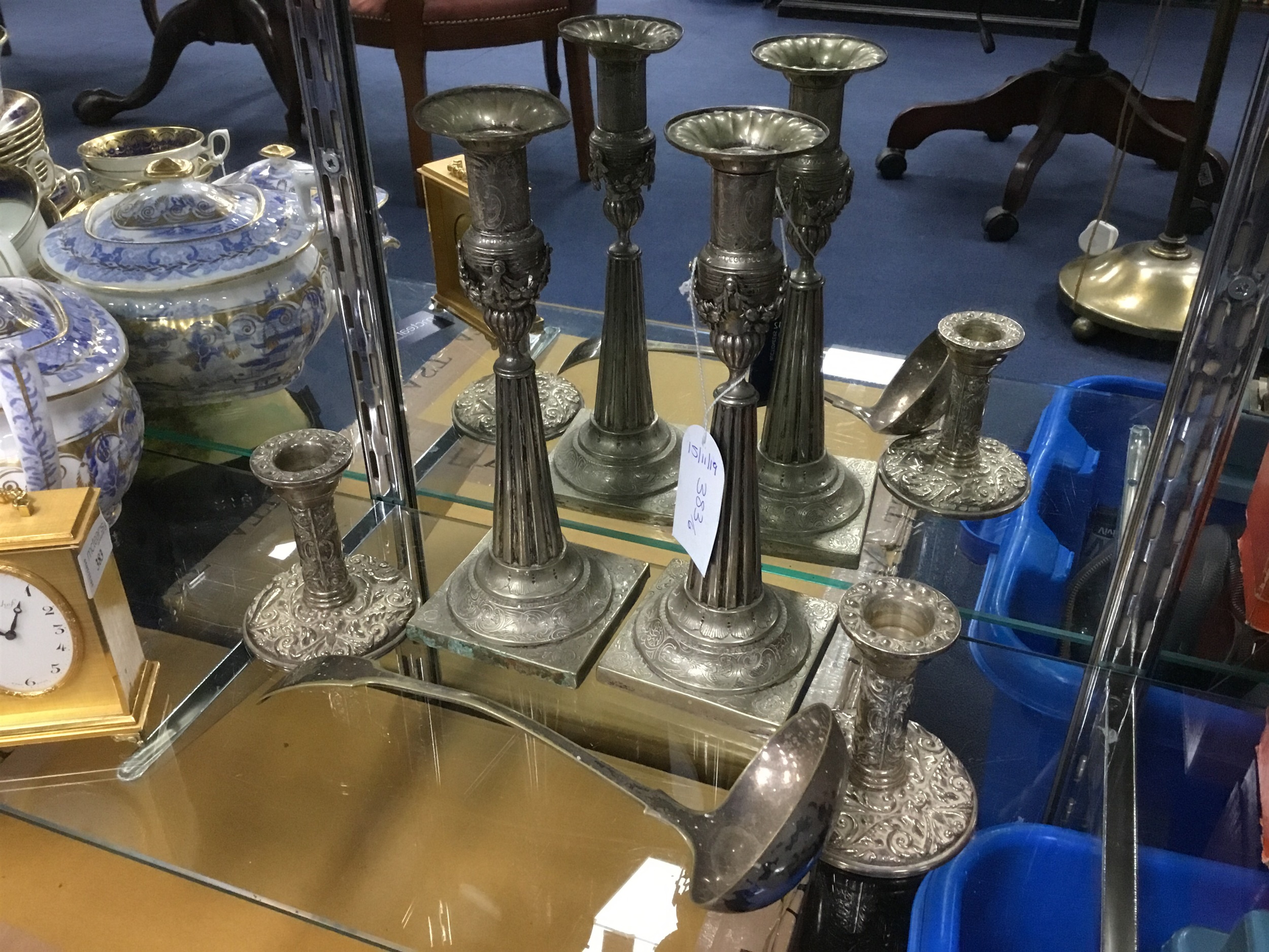 A LOT OF TWO PAIRS OF CANDLESTICKS AND A LADLE