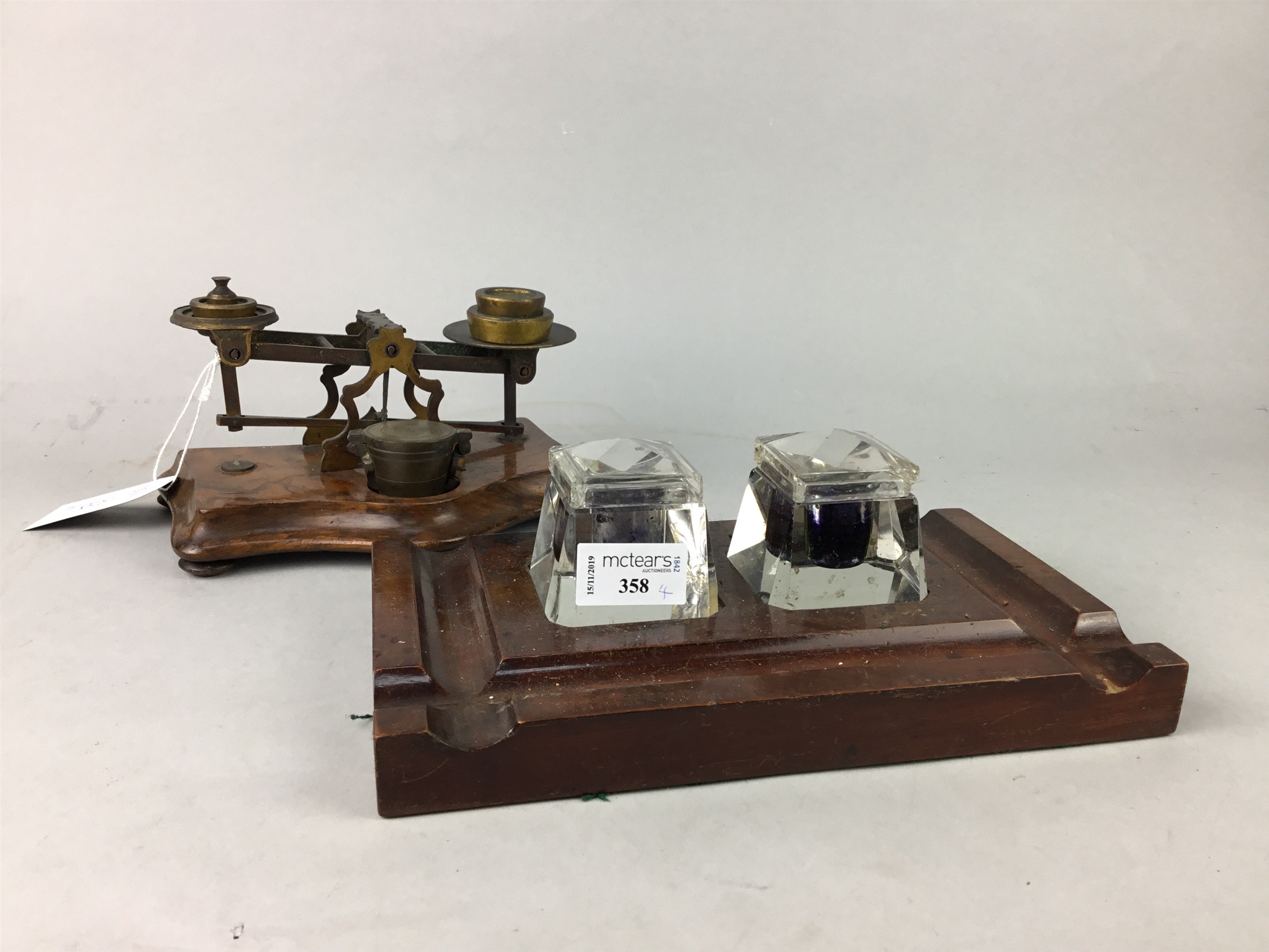 A MAHOGANY INK STAND, POSTAL SCALES AND A VINTAGE TOOL