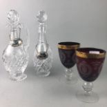 A PAIR OF RUBY GLASS GOBLETS AND TWO CRYSTAL DECANTERS WITH STOPPERS