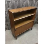 A TEAK BOOK CASE AND WRITING BUREAU