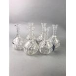 A SET OF SIX CUT GLASS DECANTERS AND OTHER GLASS WARE