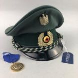 A REPRODUCTION THIRD REICH MEDAL ALONG WITH A CAP