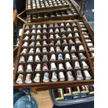 A LOT OF THIMBLES IN STAINED WOOD DISPLAY CASES