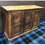 A RUSTIC THREE DOOR SIDE CABINET