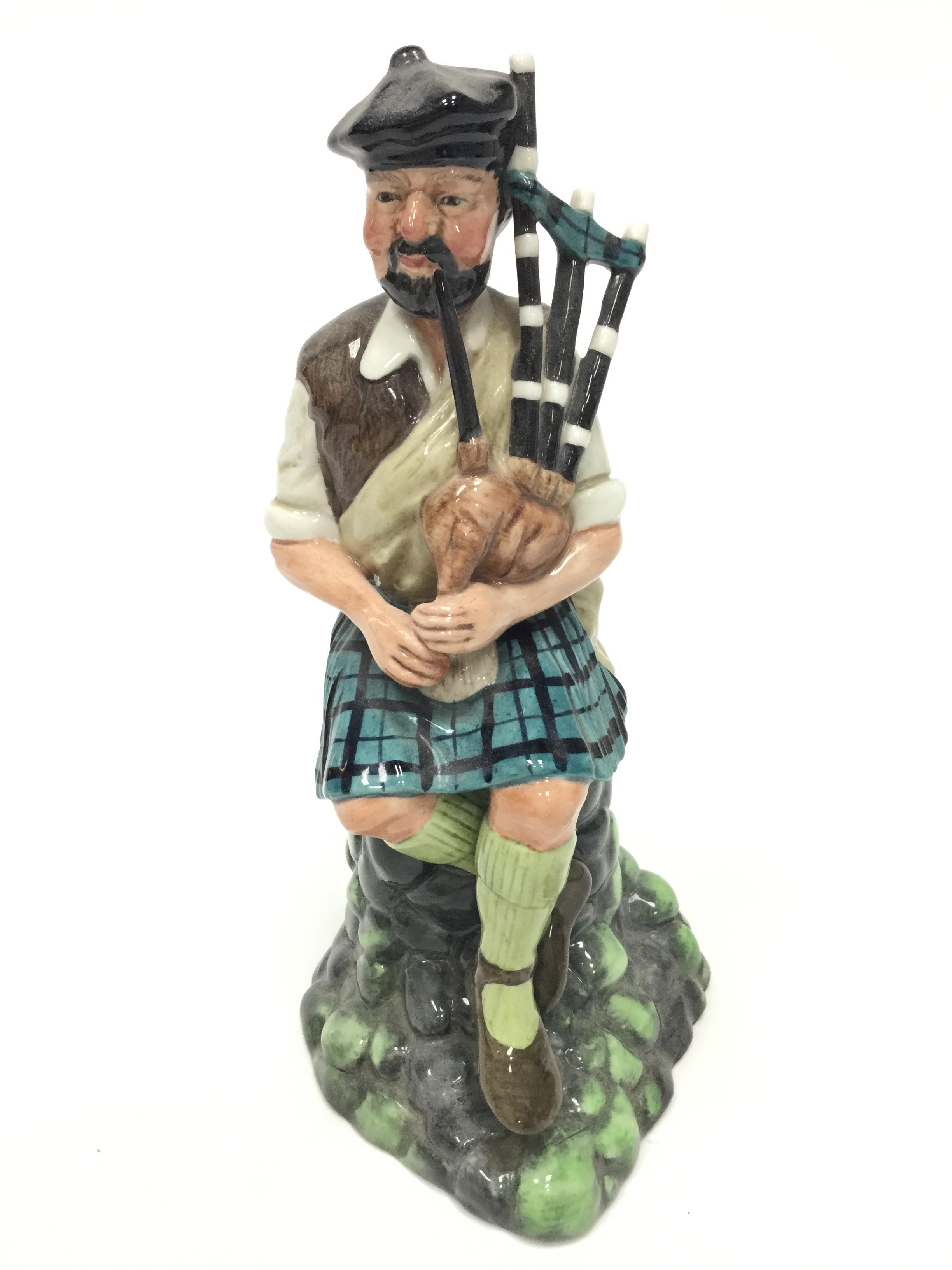 A ROYAL DOULTON FIGURE OF 'THE PIPER',