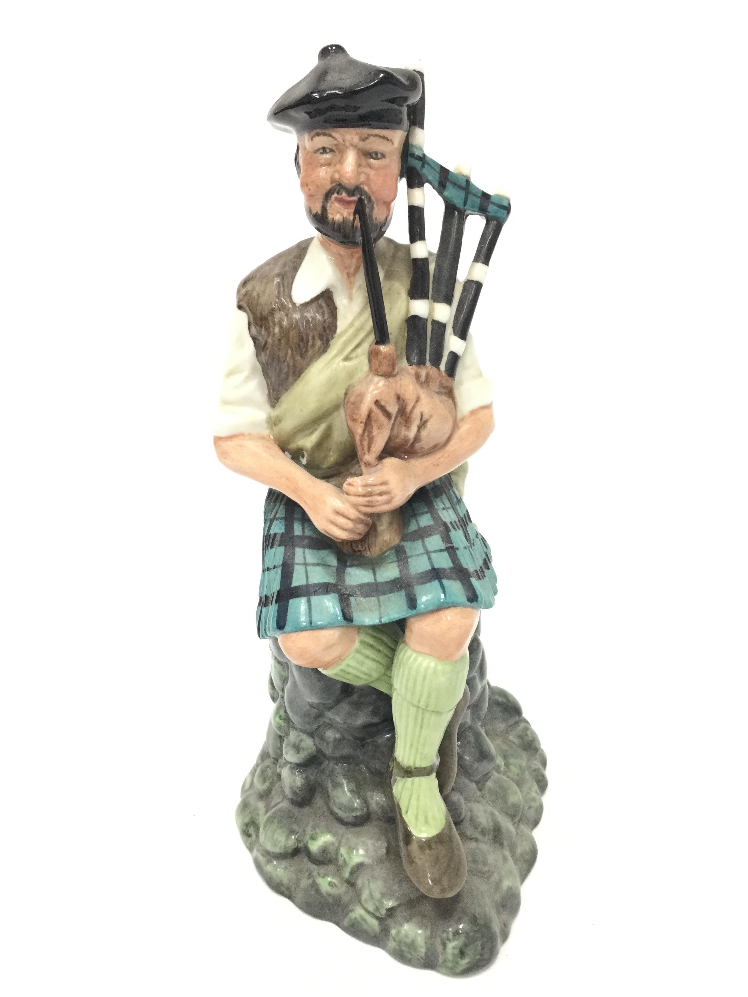 A ROYAL DOULTON FIGURE OF 'THE PIPER',