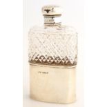 A GEORGE V SILVER MOUNTED CUT GLASS HIP FLASK, SCREW CAP, WITH A SILVER DETACHABLE BEAKER, 12.5CM H,