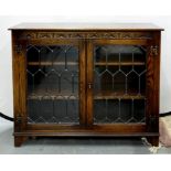 A STAINED AND CARVED OAK GLAZED BOOKCASE, 90CM H; 98 X 33CM