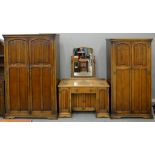 A THREE PIECE OAK BEDROOM SUITE, COMPRISING TWO WARDROBES AND A DRESSING TABLE, LARGEST WARDROBE