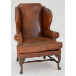 A GEORGE II MAHOGANY WINGBACK ARMCHAIR, IN BRASS NAILED BROWN HIDE, EARLY 20TH C, 120CM H