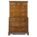 A GEORGE II WALNUT CHEST ON CHEST, C1740, the moulded cornice above three short and three graduated,