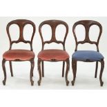 A SET OF THREE VICTORIAN CARVED MAHOGANY DINING CHAIRS