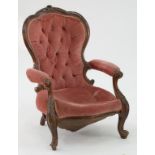 A VICTORIAN CARVED WALNUT ARMCHAIR, UPHOLSTERED IN PINK BUTTON BACK FABRIC