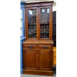 AN ART NOUVEAU STYLE BOOKCASE, THE LOWER PART FITTED WITH PANELLED DOORS, THE UPPER PART GLAZED WITH