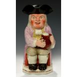A STAFFORDSHIRE EARTHENWARE TOBY JUG, C1820 with ruddy, warty face in pink coat, 25cm h++Localised