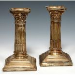 A PAIR OF EDWARD VII DWARF SILVER CORINTHIAN COLUMN CANDLESTICKS sconces, ll.5cm h, by Walter Latham