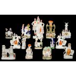 TWELVE AND A PAIR OF STAFFORDSHIRE EARTHENWARE FLATBACK GROUPS AND FIGURES, MID 19TH C including a