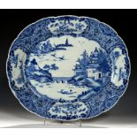 A CHINESE EXPORT PORCELAIN BLUE AND WHITE DISH, C1770-80 painted with a river scene, 42.5cm l++