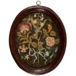 TWO ENGLISH EMBROIDERED PICTURES, C1720 AND C1770 the oval picture of flowers tied with a blue