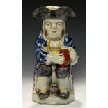 A PEARLWARE TOBY JUG, STAFFORDSHIRE OR YORKSHIRE, C1790-1820 a small barrel between the toper's feet