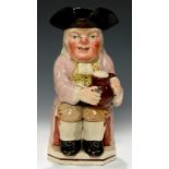 A STAFFORDSHIRE EARTHENWARE TOBY JUG, C1820-30 with ruddy, warty face in lavender coat, 25cm h++