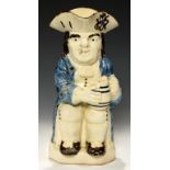 A STAFFORDSHIRE CREAMWARE TOBY JUG, C1790-1810 the toper smoking a clay pipe and holding a barrel