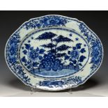 A CHINESE EXPORT PORCELAIN SHAPED OVAL BLUE AND WHITE DISH, C1780 painted with bamboo, peony and