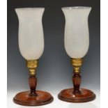 A PAIR OF ENGLISH BRASS AND TURNED MAHOGANY CANDLE LAMPS AND FROSTED GLASS SHADES, SECOND QUARTER