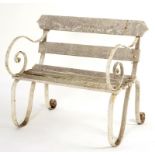 A VICTORIAN GARDEN SEAT, LATE 19TH/EARLY 20TH C with scrolling wrought iron ends and timber slats,