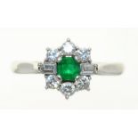 AN EMERALD AND DIAMOND CLUSTER RING IN 18CT WHITE GOLD, LONDON 1978, THE SQUARE EMERALD APPROX 0.