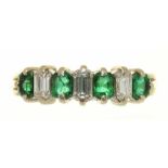 AN EMERALD AND DIAMOND RING OF WHITE GOLD WIREWORK, UNMARKED, THE EMERALDS APPROX 0.5CT, DIAMONDS