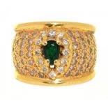 AN EMERALD AND DIAMOND COCKTAIL RING, IN GOLD MARKED 750, THE OVAL FACETED EMERALD APPROX 0.4 CT,