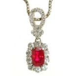 A RUBY AND DIAMOND PENDANT IN WHITE GOLD MARKED 750, TO A WHITE GOLD CABLE CHAIN MARKED 750, THE
