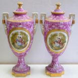 A PAIR OF VIENNA STYLE PINK GROUND PORCELAIN SHIELD SHAPED VASES AND COVERS, DECORATED WITH