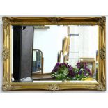 A GILTWOOD AND COMPOSITION OVERMANTEL MIRROR WITH BEVELLED PLATE, 64 X 89CM