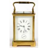 A FRENCH BRASS CARRIAGE CLOCK, THE WHITE ENAMEL MASK DIAL WITH SUBSIDIARY ALARM RING, THE MOVEMENT