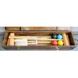 A CROQUET SET IN STAINED WOOD CASE