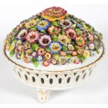 A GERMAN PORCELAIN FLORAL ENCRUSTED POT POURRI BOWL AND COVER ON THREE GILT FEET, 20CM D, PRINTED