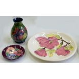 A MOORCROFT VASE, PLATE AND DISH, HIBISCUS, MAGNOLIA AND PANSY PATTERNS, VASE 13CM H, PRINTED AND