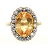 AN IMPERIAL TOPAZ AND DIAMOND CLUSTER RING IN 18CT WHITE GOLD BY GARRARD & CO LTD, LONDON 1975,