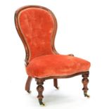 A VICTORIAN MAHOGANY NURSING CHAIR, UPHOLSTERED IN RED BUTTON BACK FABRIC